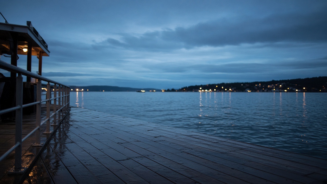 Empty ferry deck at dusk, wet planks and a distant harbor